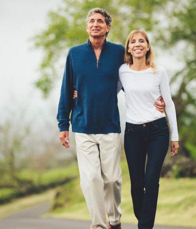 Middle-aged couple smiling and walking